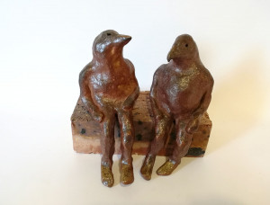wood-fired ceramic sculpture by Katja Abbott of 2 theranthropic birds in conversation