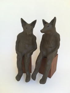 Ceramic sculpture by Katja Abbott of two therianthropic wolves in conversation