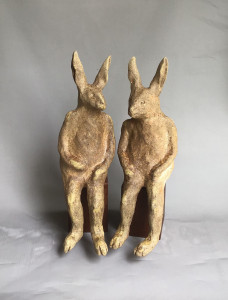 Wood-fired ceramic sculpture by Katja Abbott of two therianthrope rabbits in conversation